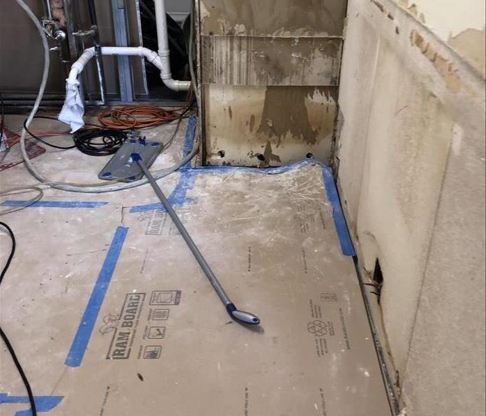 Floors and part of the wall are stripped. 