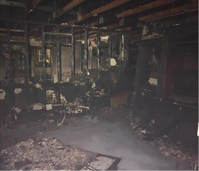 Severe fire damage inside a home, everything seems burnt